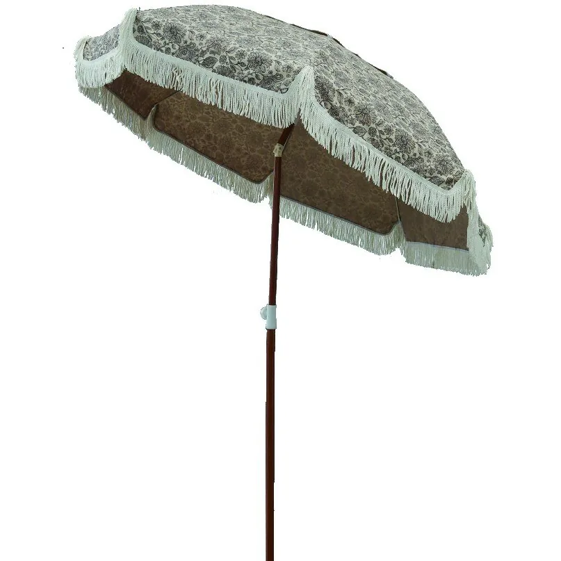 Beige beach umbrella with fringed valance and wooden pole