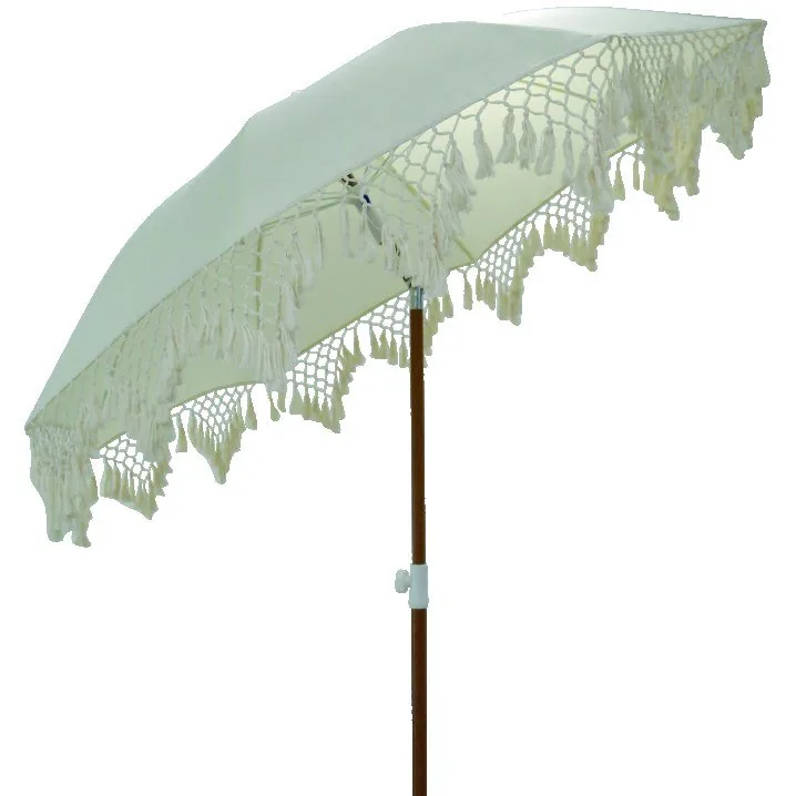 Cream beach umbrella with fringed edge and wooden pole