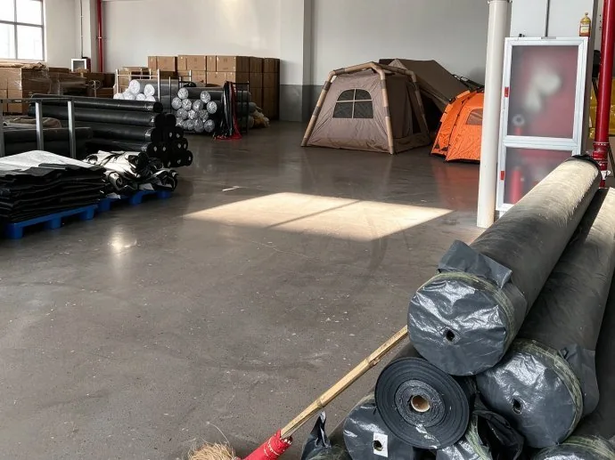 Canopy fabric rolls and tent stock in the workshop before panels are cut and sewn