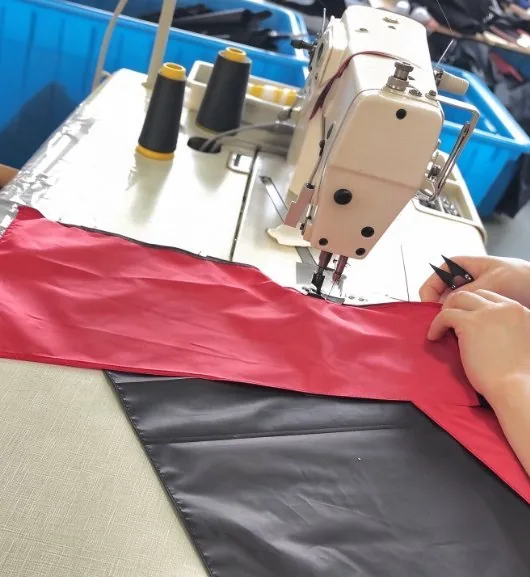 Red canopy fabric laid flat on the machine bed