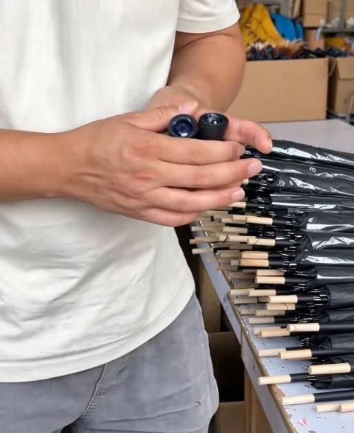 Fitting a moulded handle onto the shaft during umbrella assembly