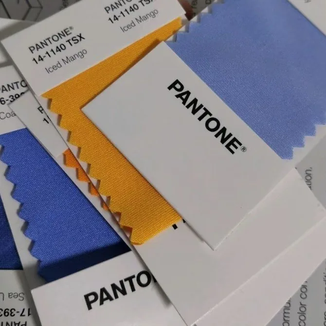 Fabric swatches compared against a Pantone TCX reference before dyeing