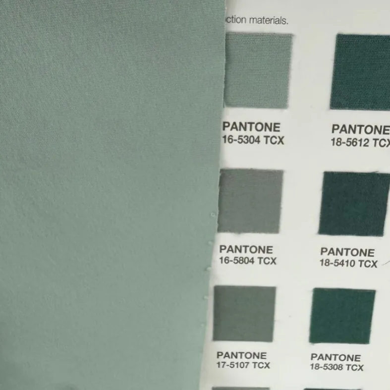 Woven fabric assessed against a strip of Pantone TCX codes