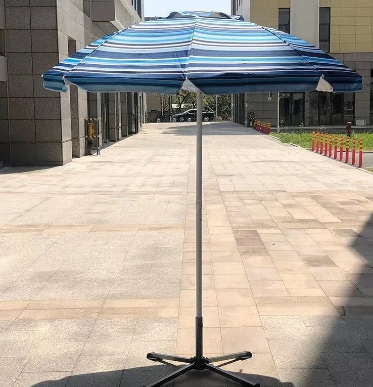 Blue and white striped canopy open over a paved courtyard