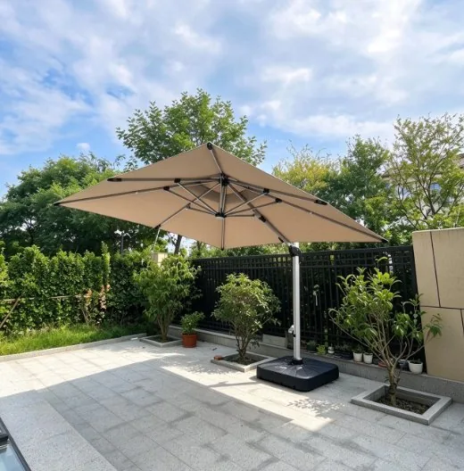 Cantilever umbrella open over paving beside a hedge