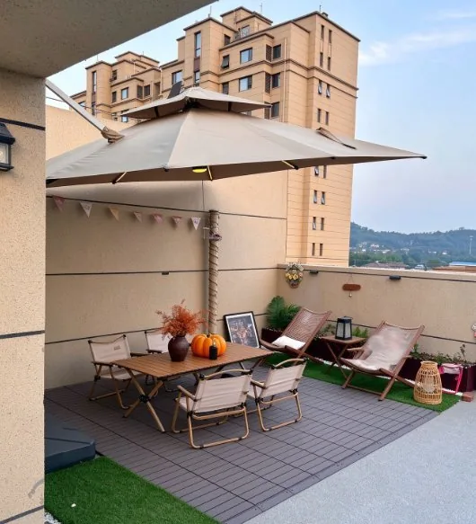 Cantilever umbrella over a table and chairs on a balcony terrace