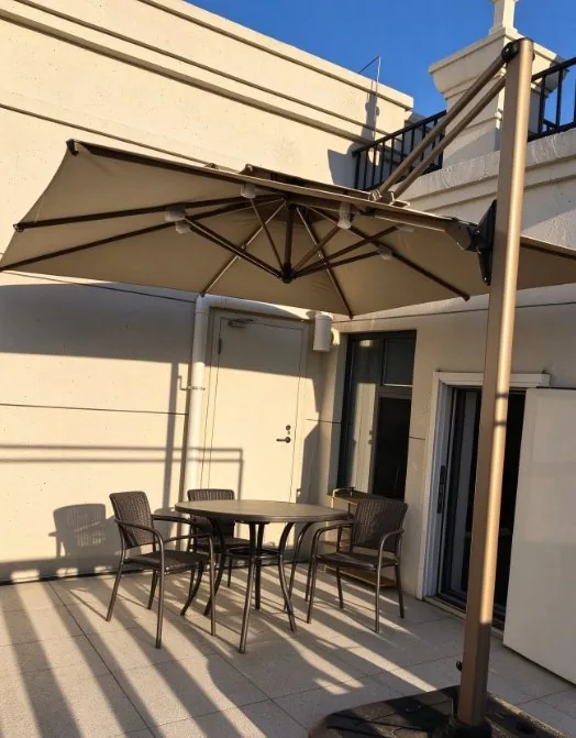 Round table and two chairs beneath a cantilever canopy, showing the overhang you are aiming for