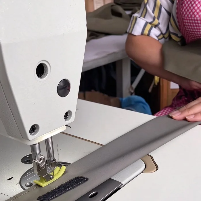 Webbing and straps sewn on an industrial machine during canopy and bag assembly